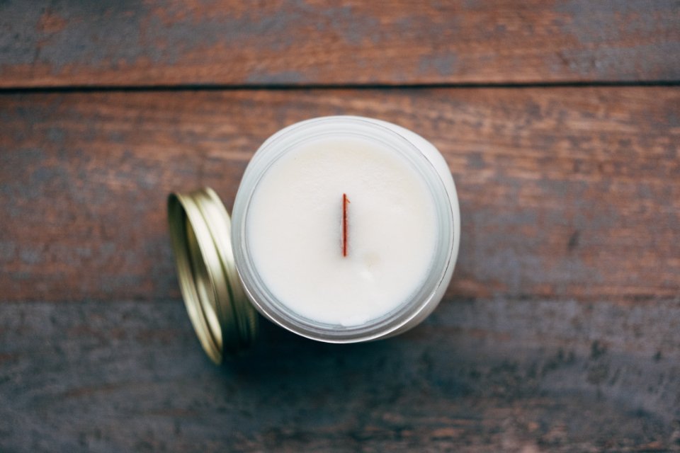 White candle in a jar, one of the classic hostess gifts