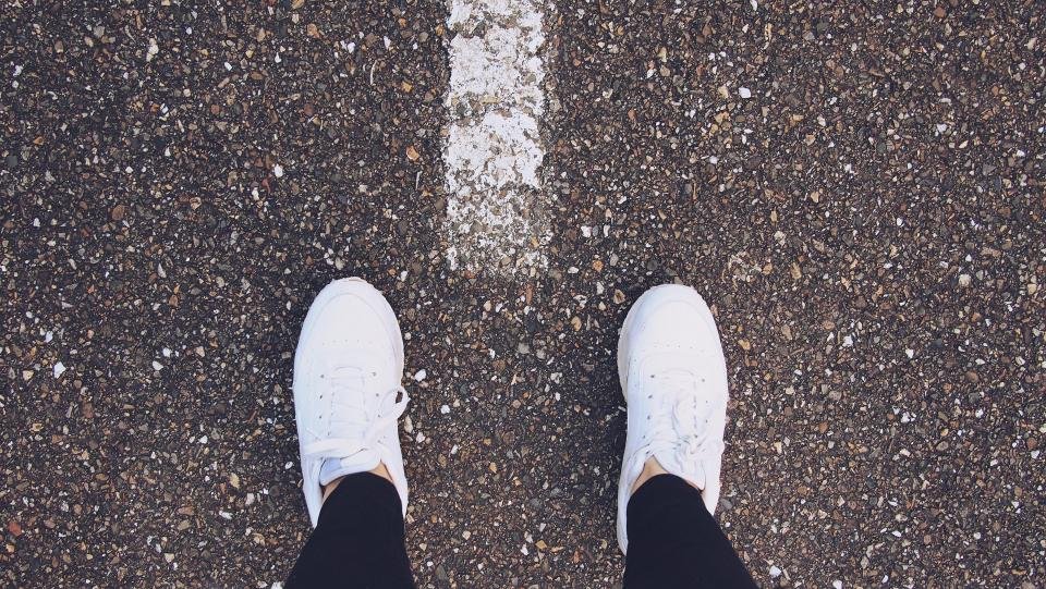 Woman wearing the best white sneakers for women on a city street