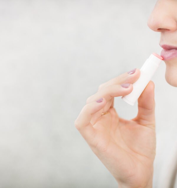 Woman applying lip balm