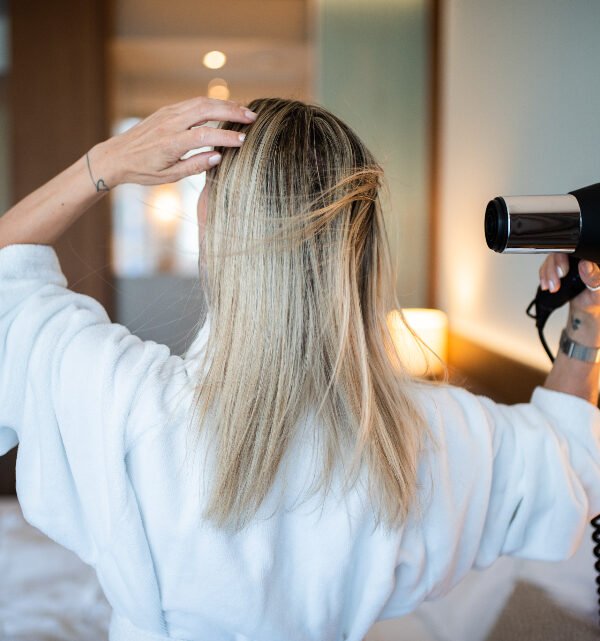 Woman blow drying hair