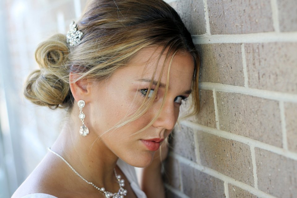 Woman with an elegant updo wearing sparkling earrings