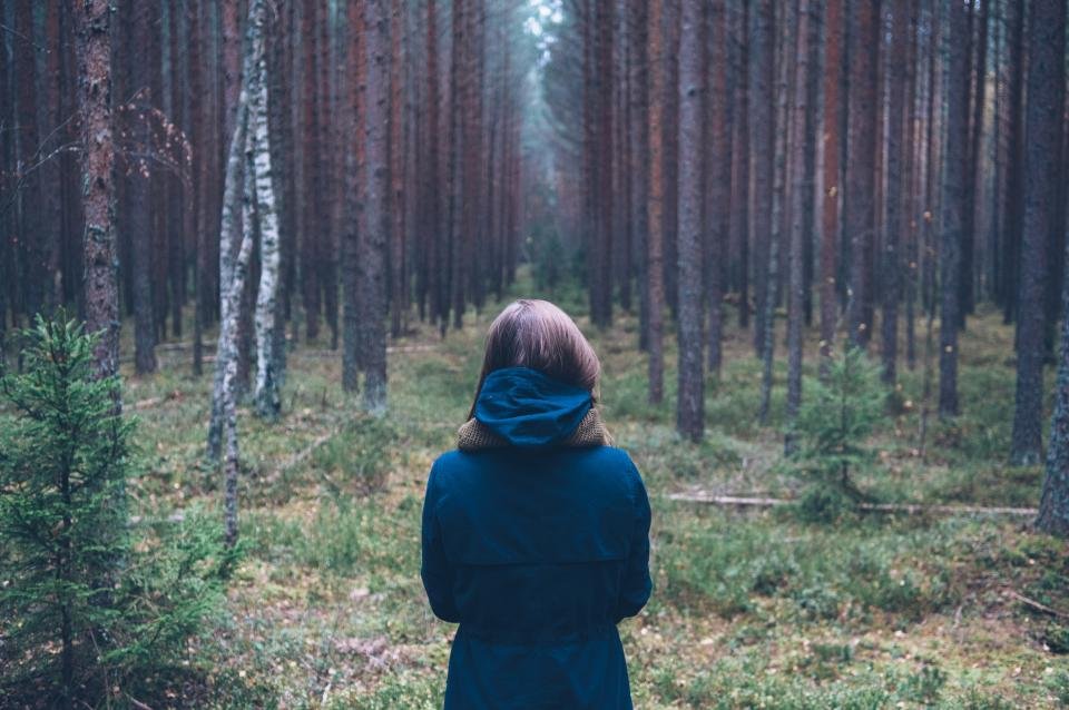 Woman in a warm jacket in a forest, the kind of day puffer vests for women are made for