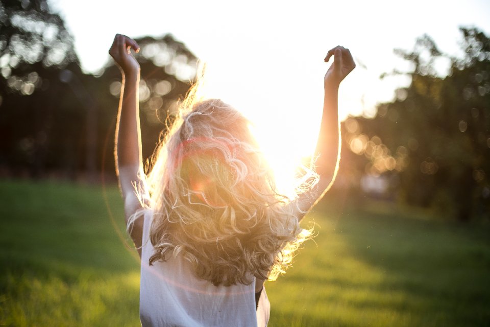 Woman with healthy curly hair after using hair repair treatments