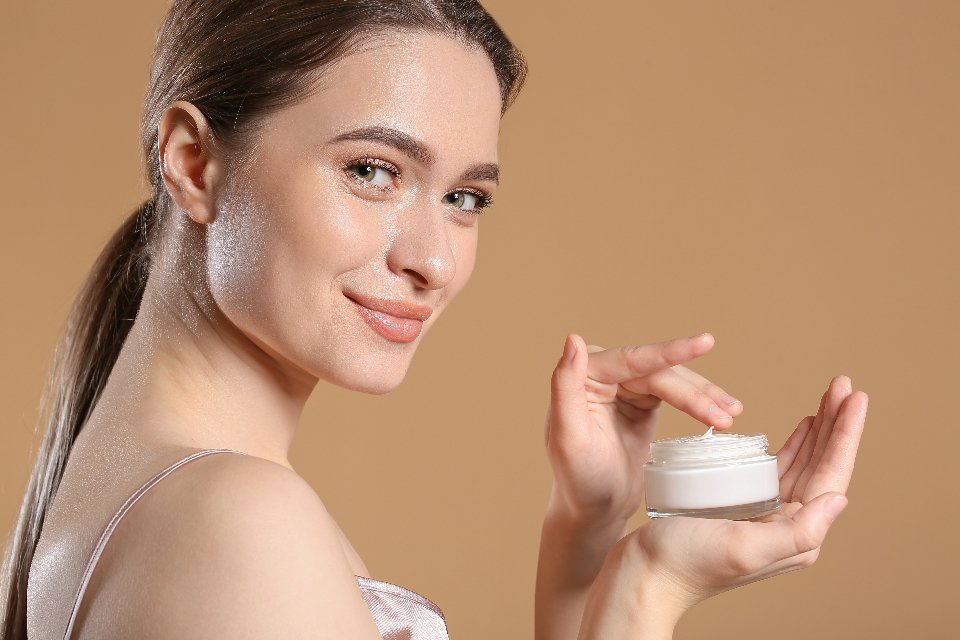 Best luxury eye creams: woman holding a jar of eye cream