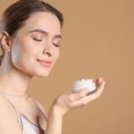 Woman holding luxury face cream
