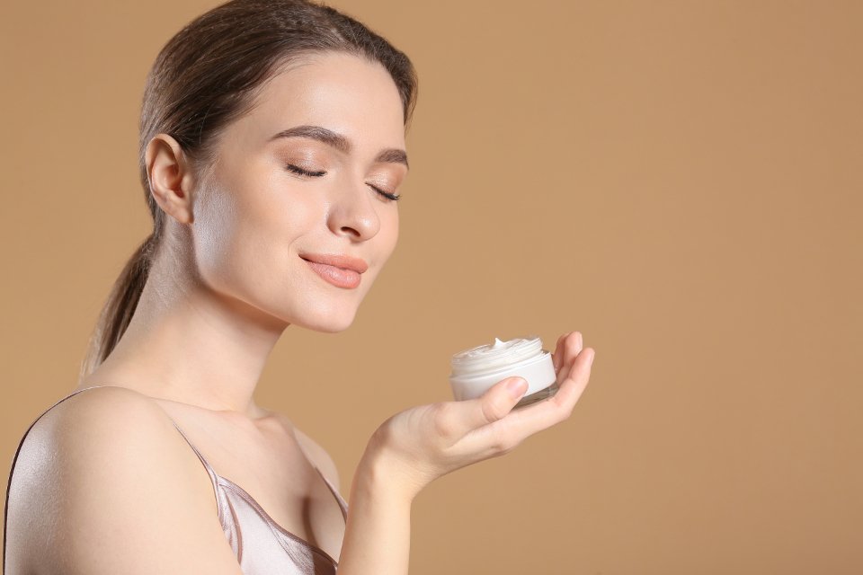 Woman holding luxury face cream