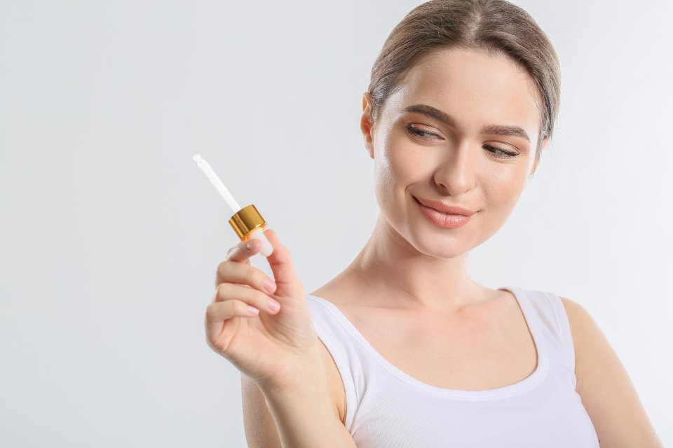 Woman holding a vitamin c serum bottle
