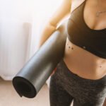 Woman holding yoga mat