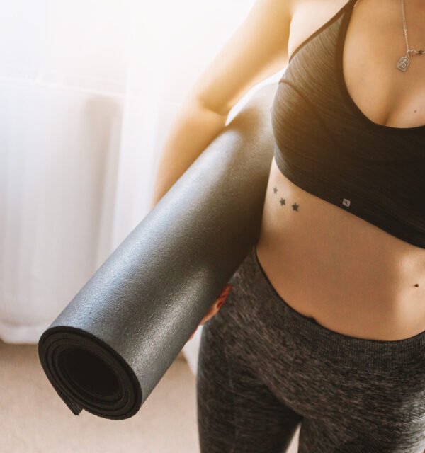 Woman holding yoga mat