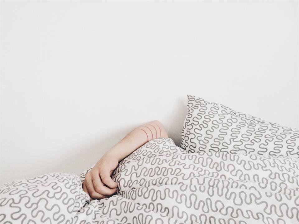 Woman resting on a soft patterned pillow in bed
