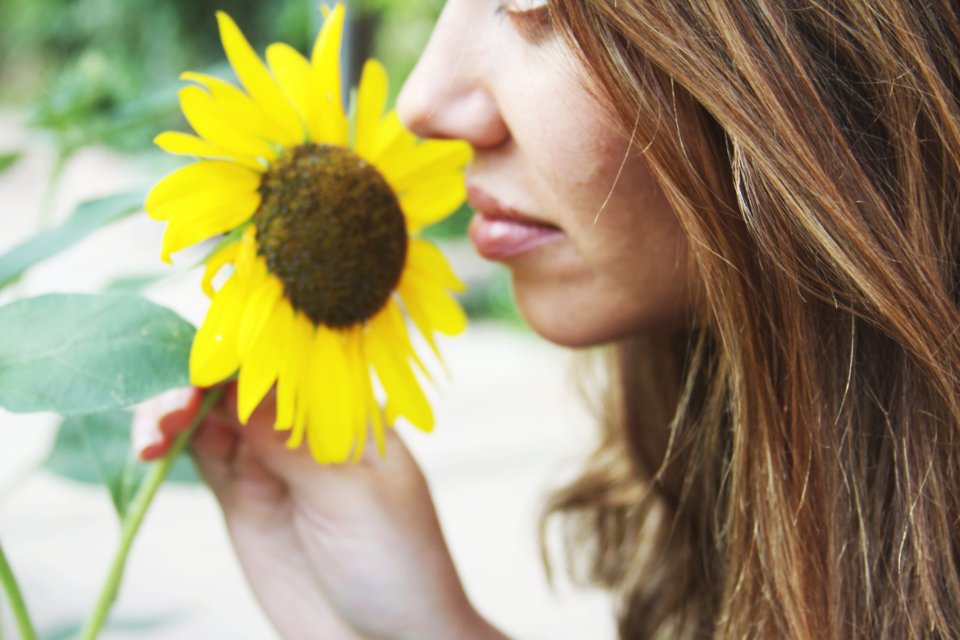 Woman enjoying a fresh floral scent outdoors