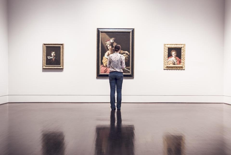 Woman viewing museum painting