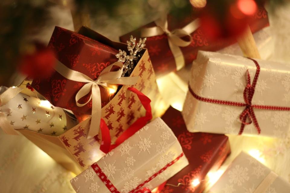 Small wrapped stocking stuffers for women glowing with holiday lights
