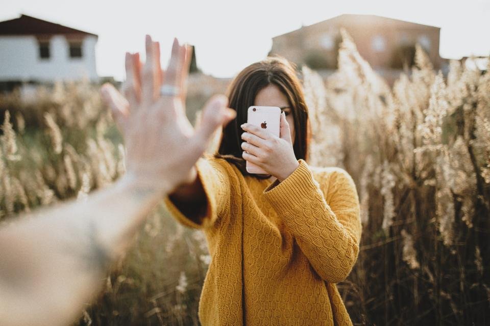 Best sweaters for women: a mustard yellow knit worn outdoors
